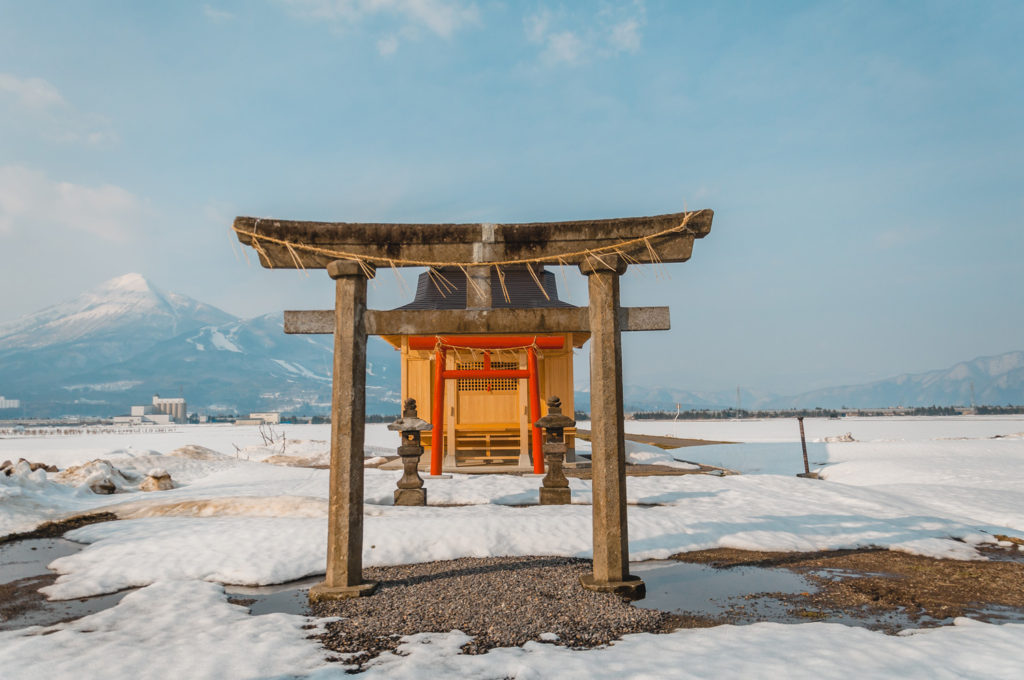 Japanese Tori in the middle of snowy Fukushima with a mountain behind