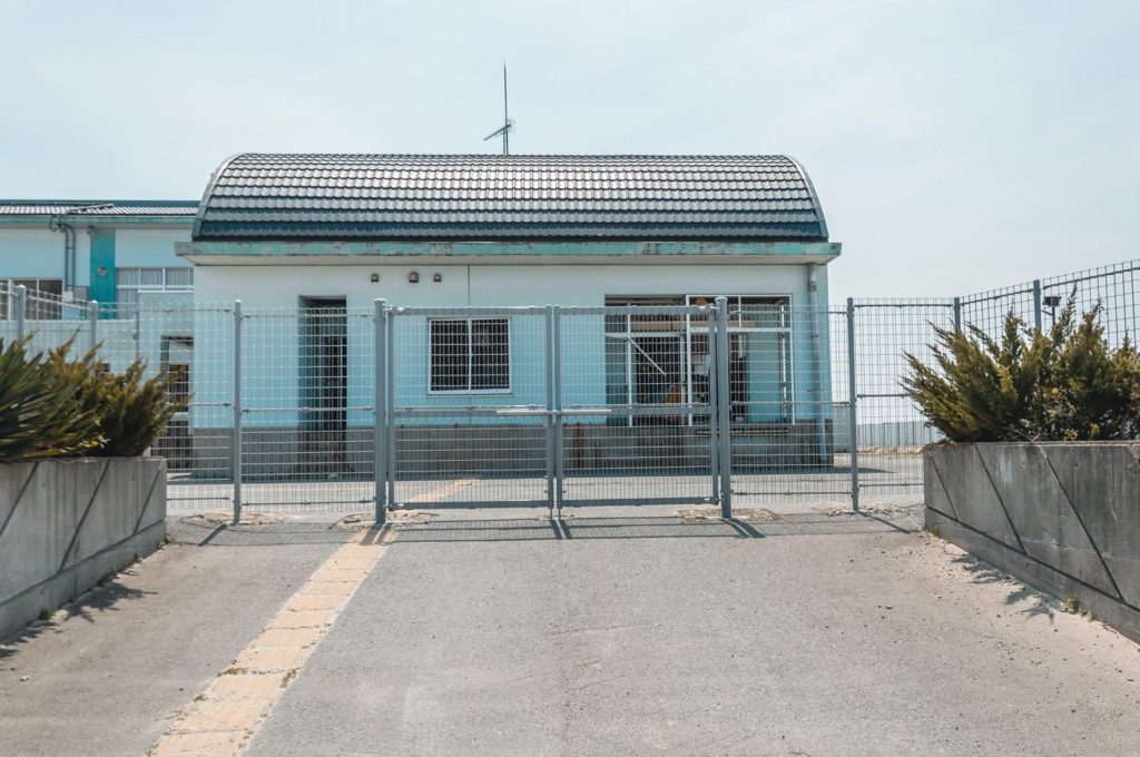 Exterior Shot of the blue building of the Abandoned Elementary School in Namie, Fukushima